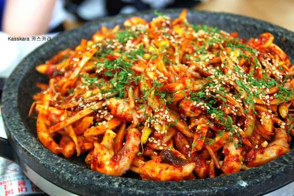 Red/Organe Octopus Stir-Fry in stone bowl, also known as Korean Nakji Bokkeum